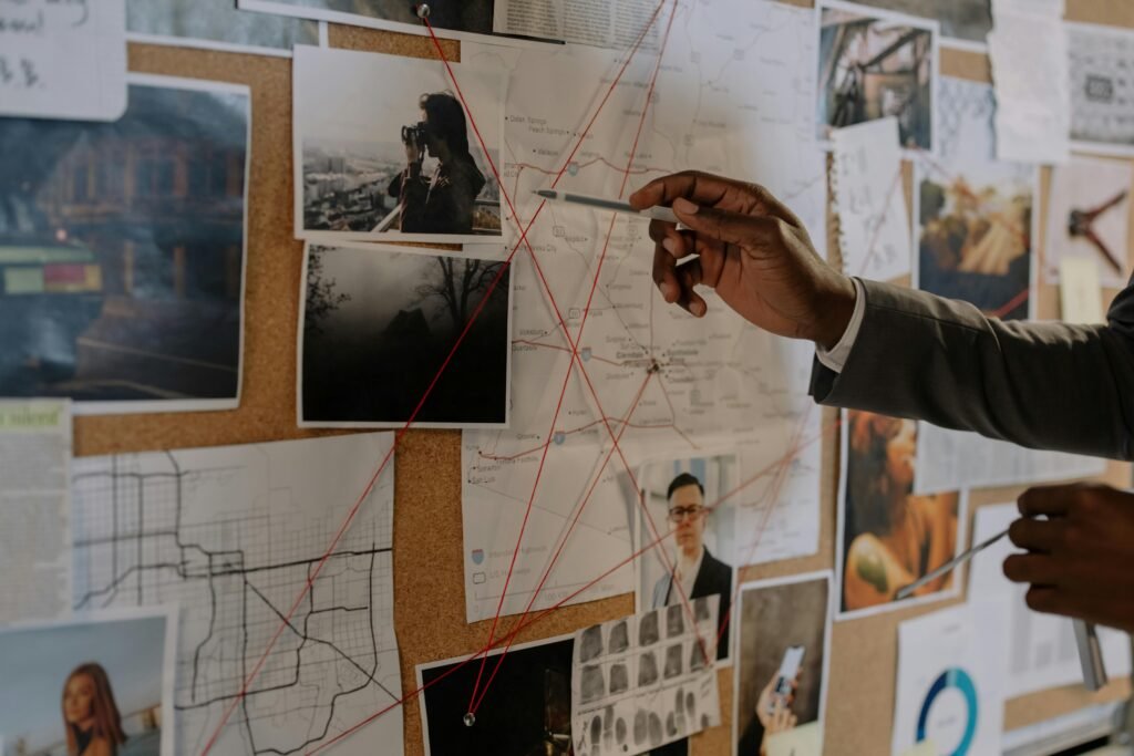 zipwp-image-8369520 Detective examines a corkboard with maps and photos to solve a mystery.